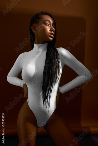African woman underwear on brown background. Young stylish fashion girl portrait