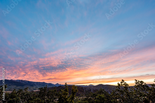 Aspen, Colorado with rocky mountains Snowmass peak and vibrant color of sunset orange light in blue sky wide angle view of skyscape