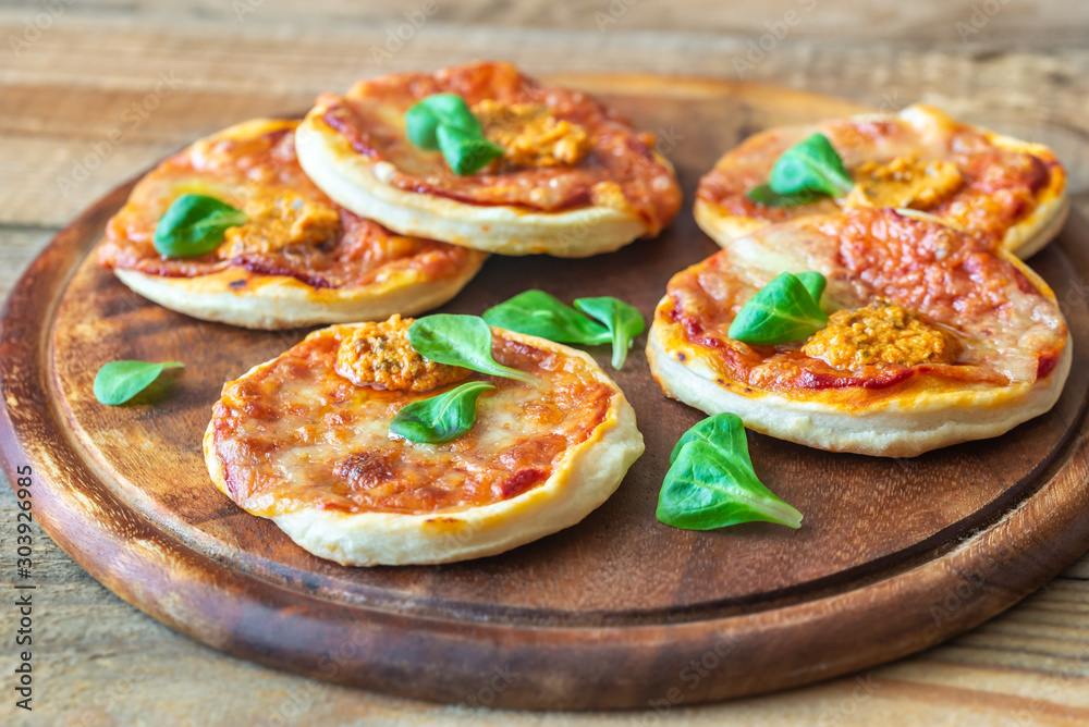 Mini pizzas on the wooden board Mini pizzas on the wooden board