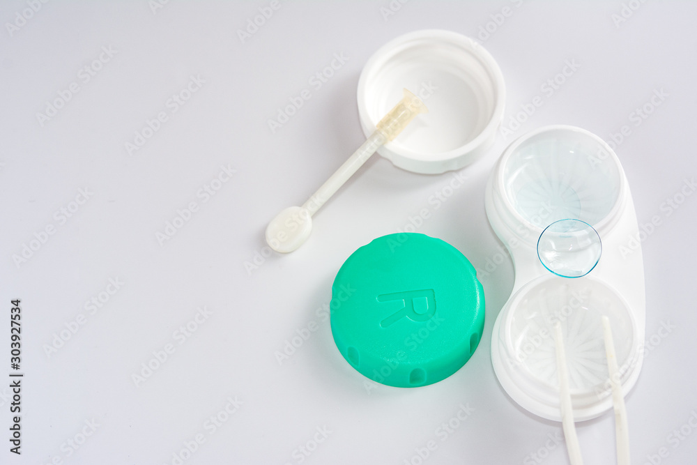 container for soft contact lenses and lens on light background, the concept of care for contact lenses container for soft contact lenses and lens on light background, the concept of care for contact lenses