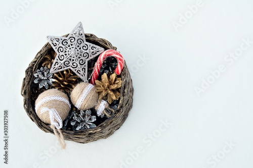 basket with Christmas toys in the snow © daniiD