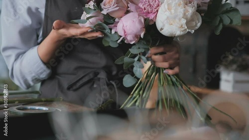 Female florist enjoying freshly made flower bouquet