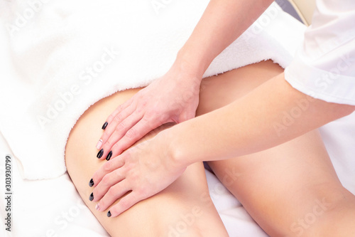 Fototapeta Naklejka Na Ścianę i Meble -  Anti cellulite massage for young woman in beauty salon. Perfect skin fat burning beauty concept