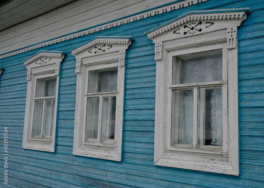 carved shutters on the Windows of a wooden house