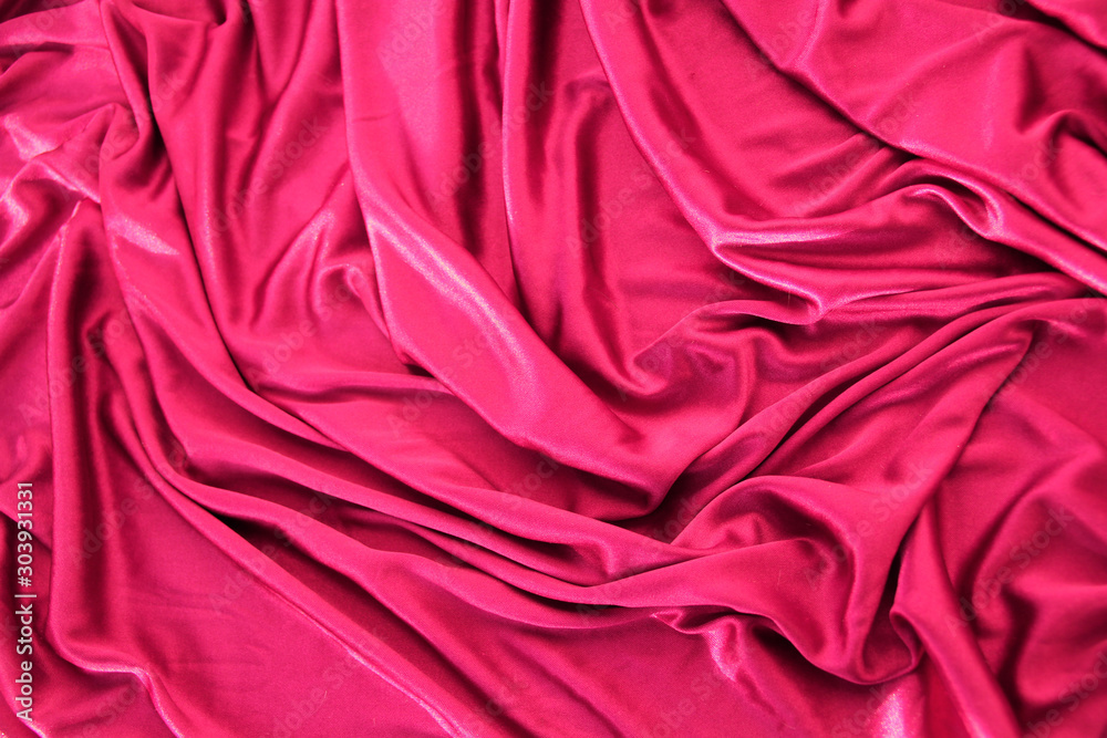 beautiful silk fabric of delicate pink color draped with small folds ...