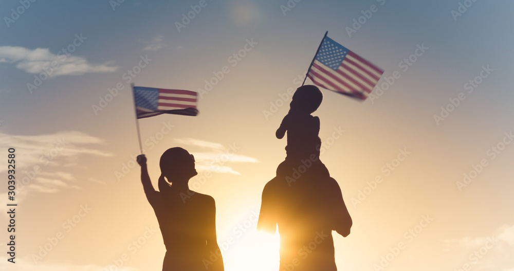 Patriotic man, woman, and child waving American flags in the air.  - obrazy, fototapety, plakaty 
