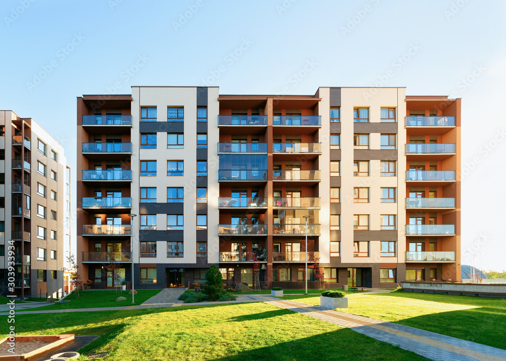 Apartment residential home facade architecture and outdoor facilities. Blue sky on background.
