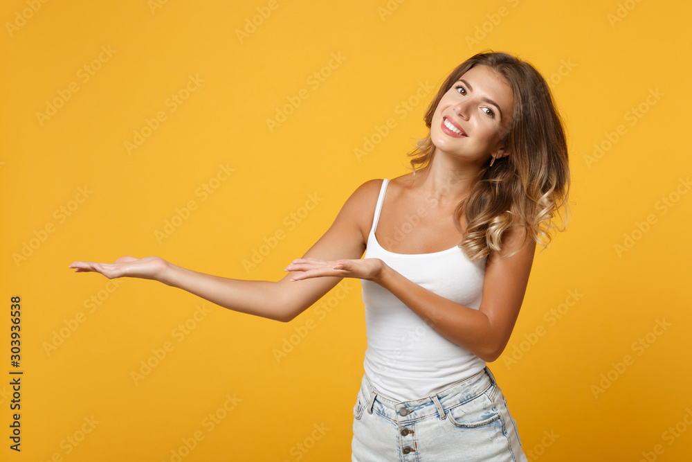 Φωτογραφία Smiling young woman girl in light casual clothes posing isolated on yellow orange wall background studio portrait