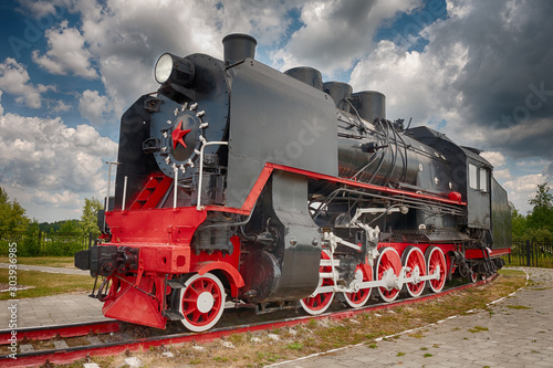 vintage steam train hurtling at speed along the rails close-up, retro vehicle, steam engine