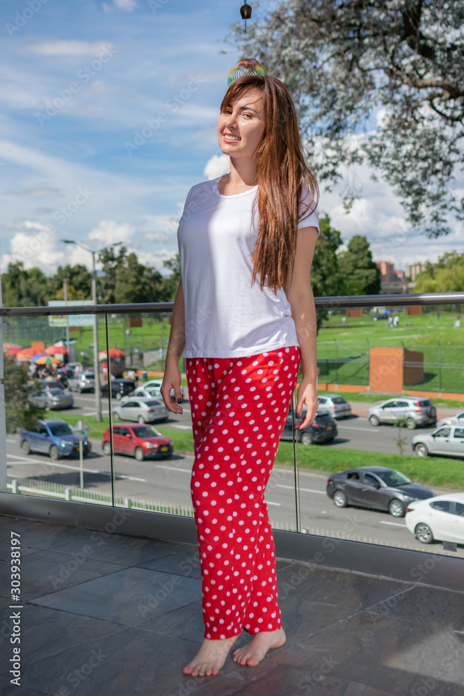 beautiful latin woman in pajamas on the terrace