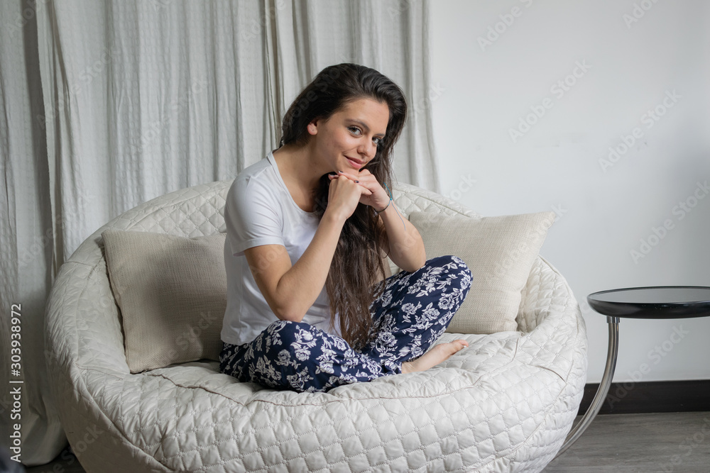 beautiful girl sitting on a chair, relaxed, wearing pajamas beautiful girl sitting on a chair, relaxed, wearing pajamas