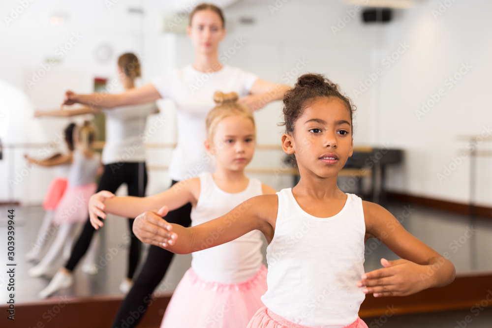 Dance teacher helping her little girls students
