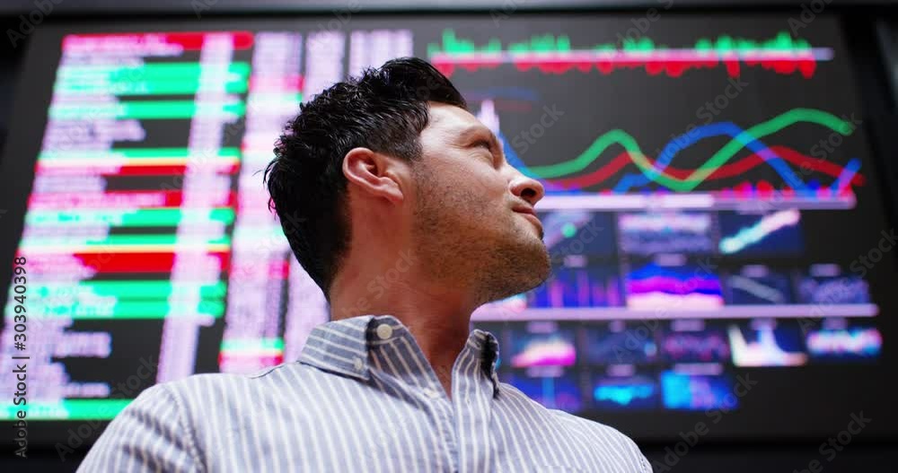 4K Close up of happy & successful stock market trader watching the world markets 4K Close up of happy & successful stock market trader watching the world markets