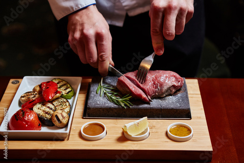 meat grilled on astone with vegetables photo