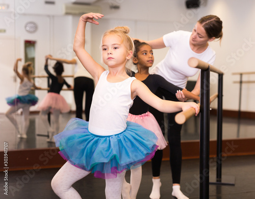 Ballet trainer teaching two little girls
