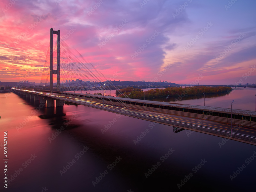 Automobile and railroad bridge in Kiev, the capital of Ukraine. Bridge at sunset across the Dnieper River. Kiev bridge against the backdrop of a beautiful sunset in Kiev. Bridge in evening sunshine Automobile and railroad bridge in Kiev, the capital of Ukraine. Bridge at sunset across the Dnieper River. Kiev bridge against the backdrop of a beautiful sunset in Kiev. Bridge in evening sunshine