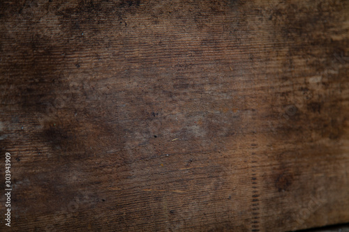 Image of a wooden table in front of an abstract background.