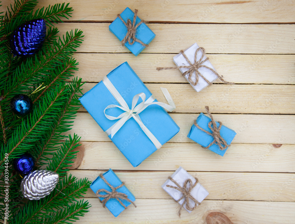 Christmas toys with fir branches on a wooden table, gift box, empty place, New Year concept. View from above. Christmas toys with fir branches on a wooden table, gift box, empty place, New Year concept. View from above.