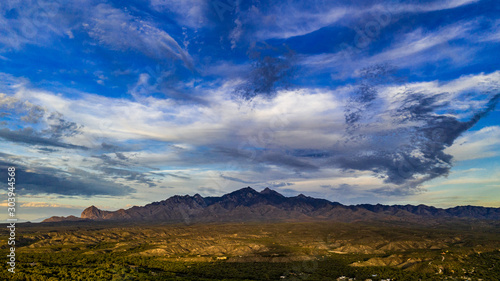 Sunset  aerial landscapes of Santa Rita Mountains from above Tubac  Arizona with warm   golden plains  purple mountains  blue sky with colorful clouds on a Fall day 