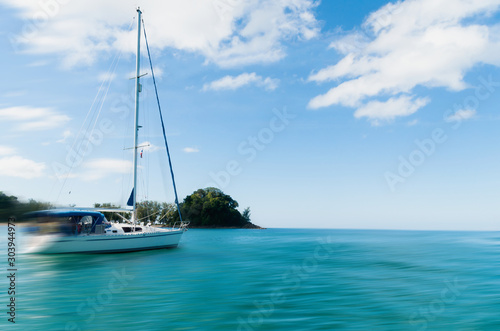 Fototapeta Naklejka Na Ścianę i Meble -  Sailboat in the sea in the evening sunlight over beautiful sky background, luxury summer adventure, active vacation in Thailand