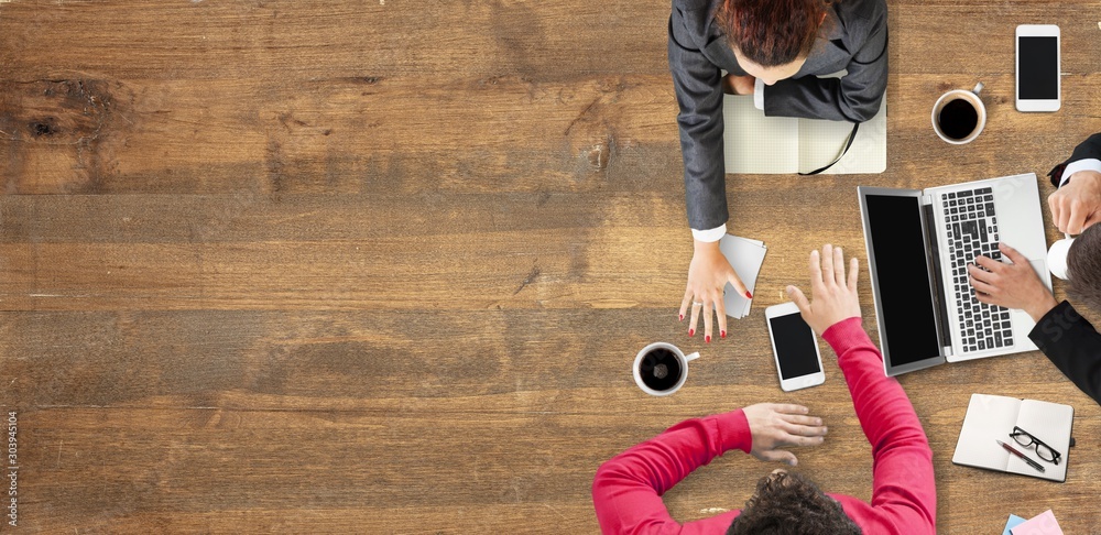 Φωτογραφία Businesspeople at work with laptop and gadgets, top view on wooden background