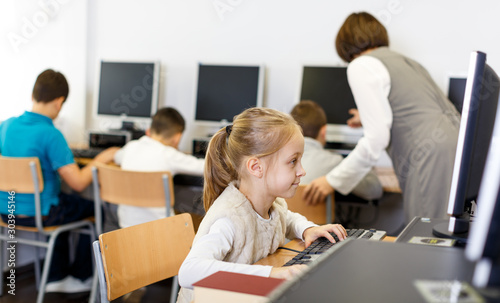 Tween girl during lesson in computer room