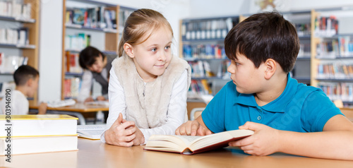 Two school children reading in school library