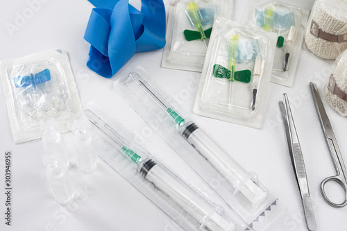 medical emergency set with two syringes, tweezers and scissors, serum capsules, vials, pressure gum and bandages