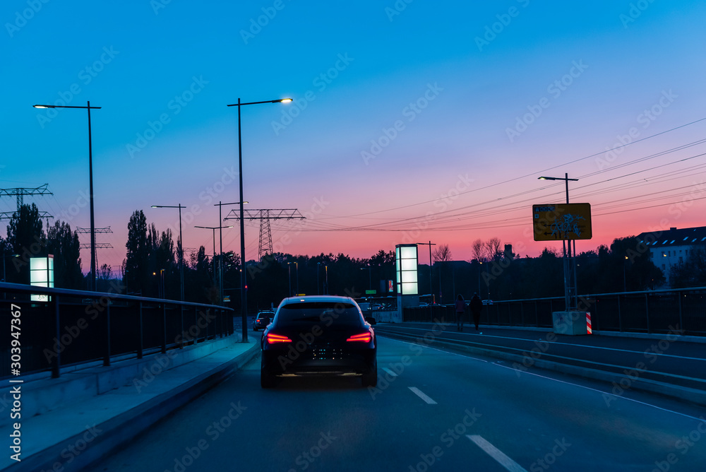 A driving car on a road, driving car at dusk, sunset, colorful, evening, cars A driving car on a road, driving car at dusk, sunset, colorful, evening, cars