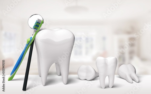 Big tooth model and toothbrush on background