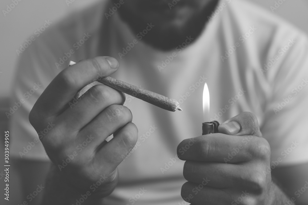 rolling a marijuana weed joint . Man rolling cannabis blunt. Close up