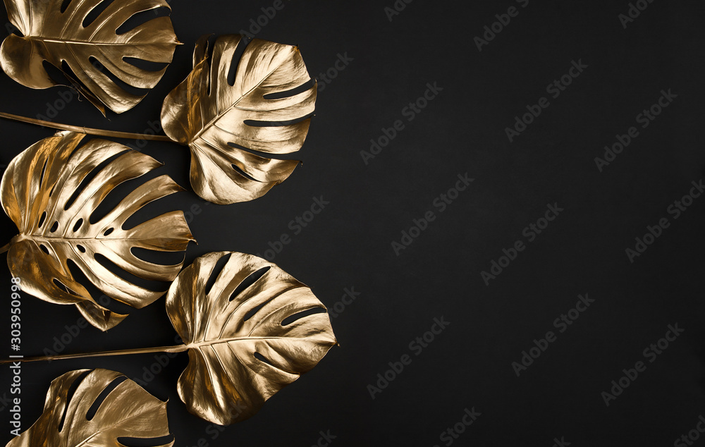 Trendy gold tropical monstera leaves on black background border frame - obrazy, fototapety, plakaty 