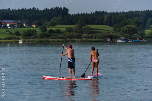 man and woman kayaking in lake