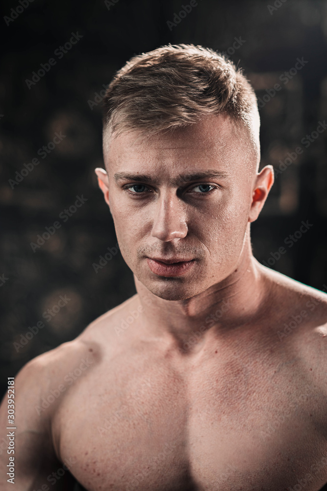 Portrait of a sexy young athletic fair-haired man with a naked torso. Portrait of a sexy young athletic fair-haired man with a naked torso.