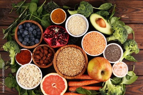 Fototapeta Naklejka Na Ścianę i Meble -  Healthy food clean eating selection: fruit, vegetable, seeds, superfood, cereals, leaf vegetable on rustic background