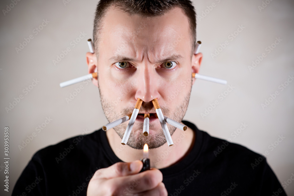 unshaven man looks into the camera, intending to light a lot of