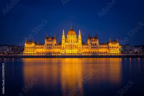 The Hungarian Parliament in symmetry after sunset in blue hour.