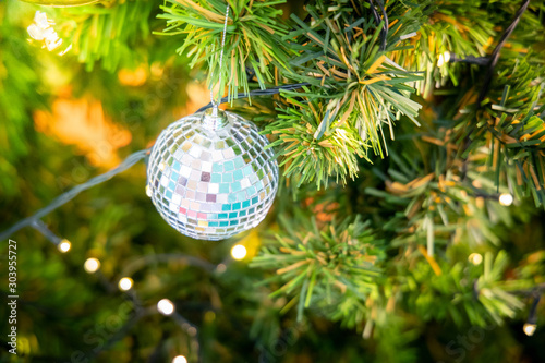 Gold Christmas background of de-focused lights with decorated tree