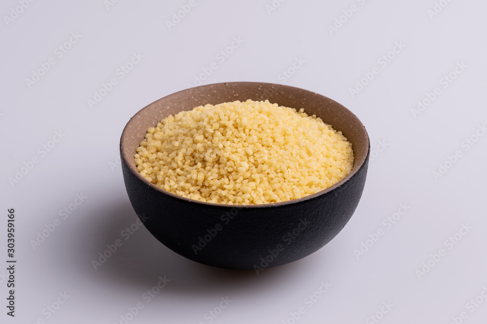 Dry couscous isolated on white background, soft light, copy space. Dry couscous isolated on white background, soft light, copy space.