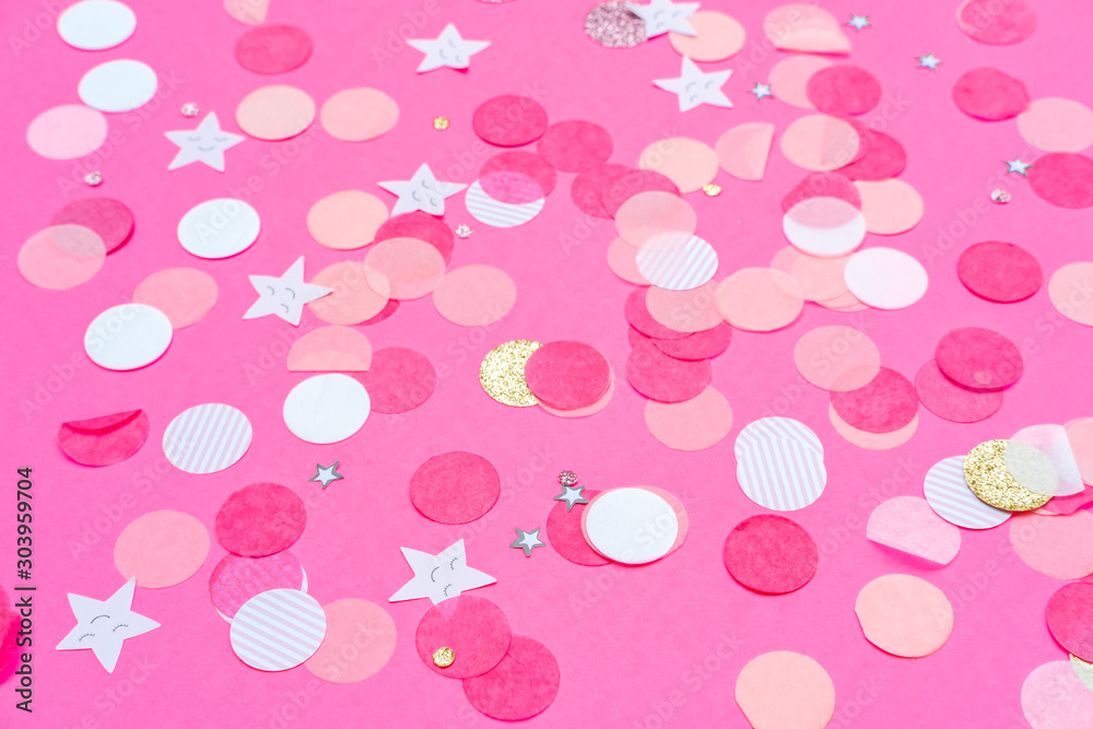 Multicolor pink, gold and white confetti on the bold pink background, holiday celebration backdrop, Flat lay style