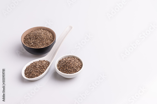 Chia seeds isolated on white background, angle view, copy space, studio shot, soft light. Latin name (Salvia hispanica).