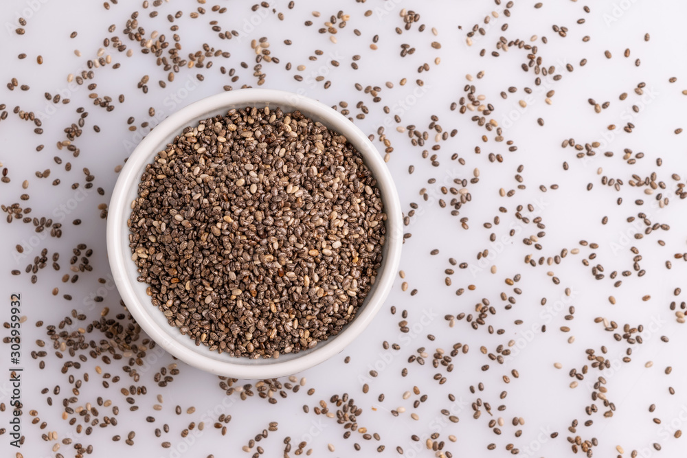 Chia seeds isolated on white background, angle view, copy space, studio shot, soft light. Latin name (Salvia hispanica). Chia seeds isolated on white background, angle view, copy space, studio shot, soft light. Latin name (Salvia hispanica).