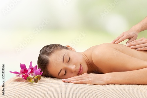 Beautiful young woman relaxing with massage at beauty spa