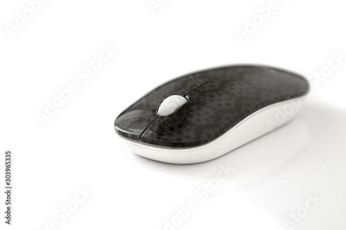 Computer wireless mouse on a white table.
