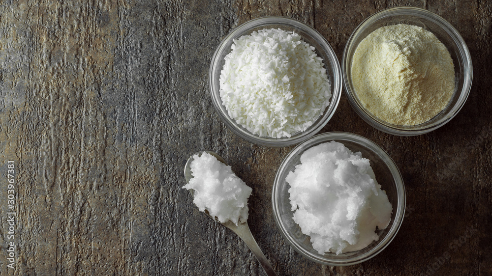 natural and organic coconut oil, coconut flour, coconut shreds ingredients in glass bowls natural and organic coconut oil, coconut flour, coconut shreds ingredients in glass bowls