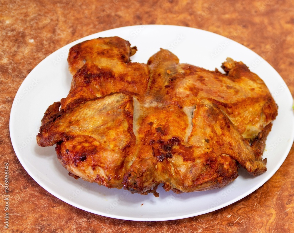 Fried chicken, chicken tobacco, on a plate. Fried chicken, chicken tobacco, on a plate.