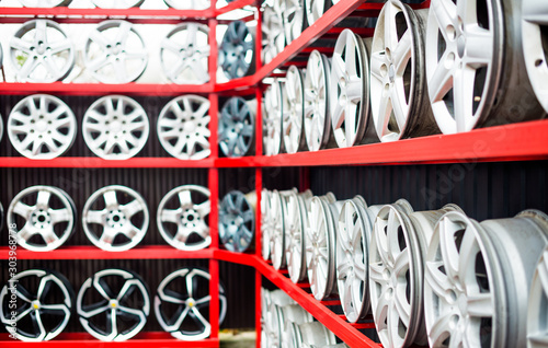 used and new chrome car wheels on street shop shelfs in line