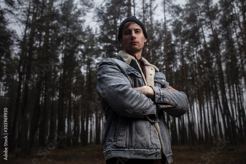  Young fashion lumberjack in the forest.Stylish lumberman getting ready for work. Lifestyle. © nick_fedirko