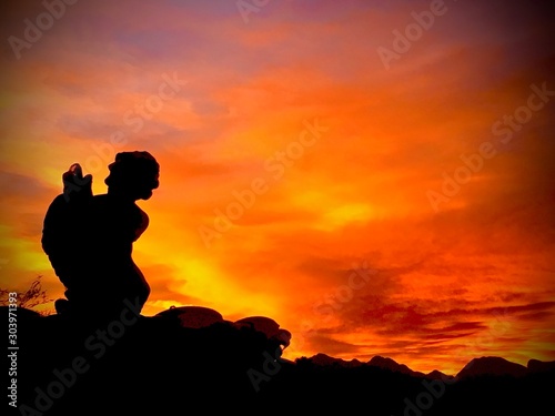 silhouette of man on top of mountain