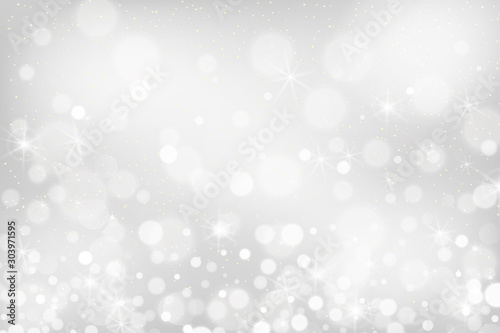 Silver bokeh background. Christmas glowing lights with sparkles. Holiday decorative effect.